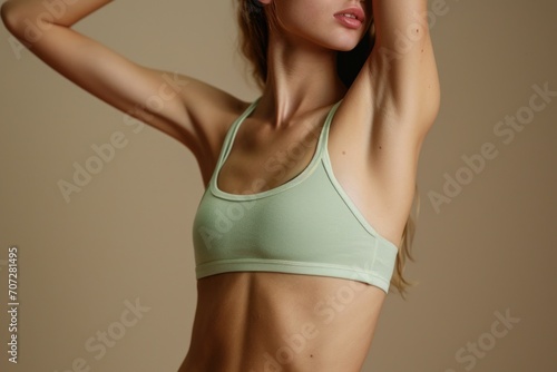 A beautiful young woman wearing a green sports bra top. Versatile image suitable for fitness, exercise, and health-related content