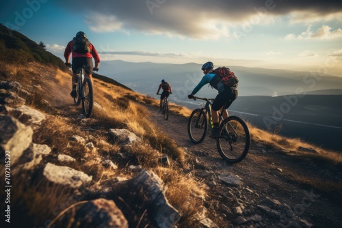Mountain bikers riding on rugged trail in hills