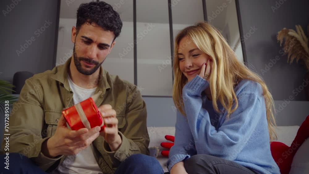 Portrait of happy and smiling young woman and man hugging and holding red gift box. Portrait of happy and smiling young woman and man hugging and holding red gift box.