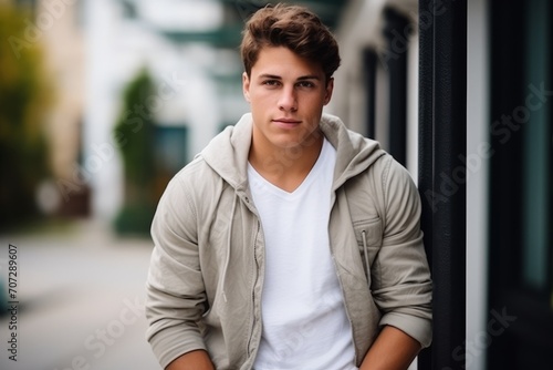Portrait of a handsome young man in a urban setting looking at the camera