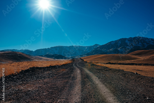Autumn mountain landscape with dirt road in Asia
