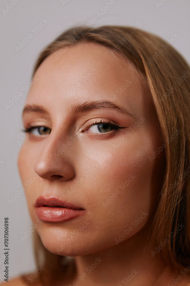 Minimalistic beauty portrait of a beautiful girl with makeup and emotions on a light background Minimalistic beauty portrait of a beautiful girl with makeup and emotions on a light background