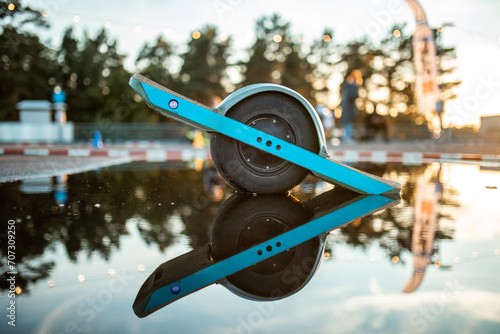 innovative one wheel electric skateboard reflects on water, showcasing alternative urban transport