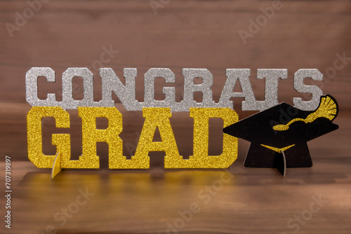 A decorative glitter congrats grad sign