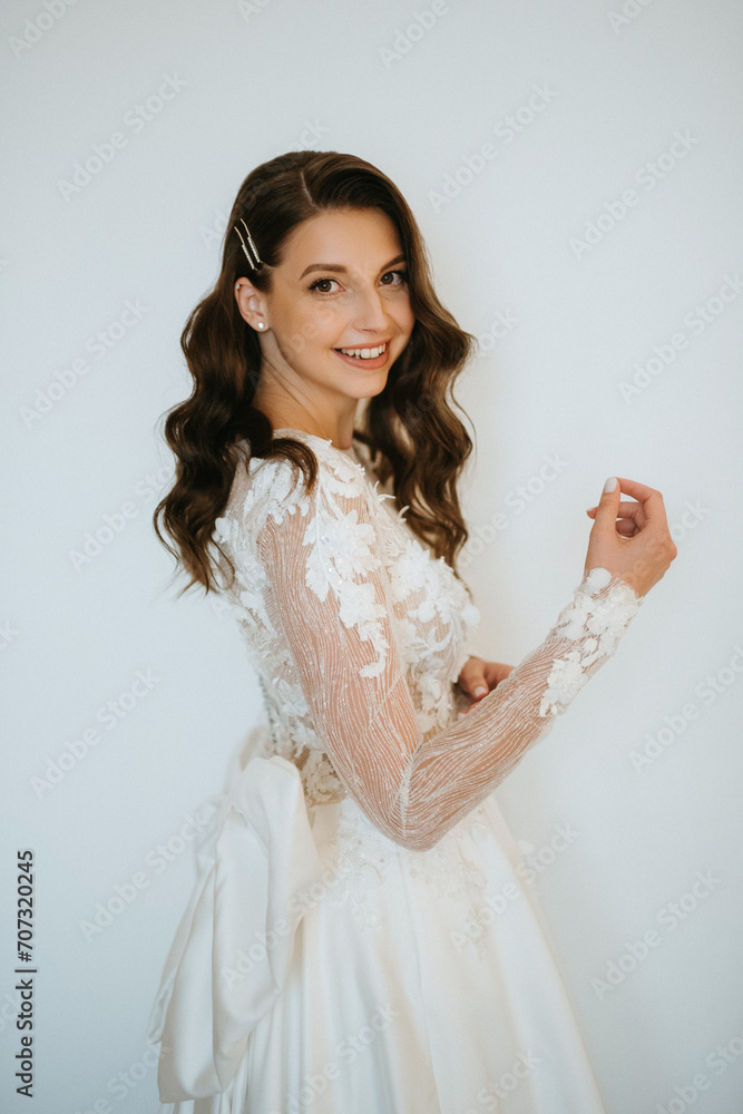 brown-haired girl puts on a wedding dress brown-haired girl puts on a wedding dress