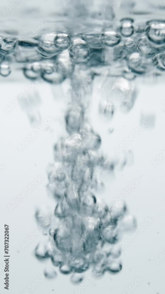 Vertical shot pouring water with air bubbles and splashes on white background, water flowing, underwater bubbles
Vertical shot pouring water with air bubbles and splashes on white background, water flowing, underwater bubbles