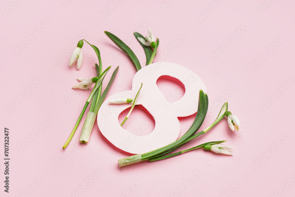 Beautiful snowdrops and number 8 on pink background