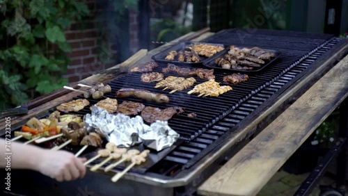 Meats and shrimp grilled on a large barbecue
