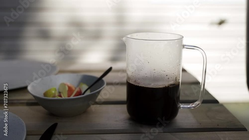 Coffee pouring into a french press outside