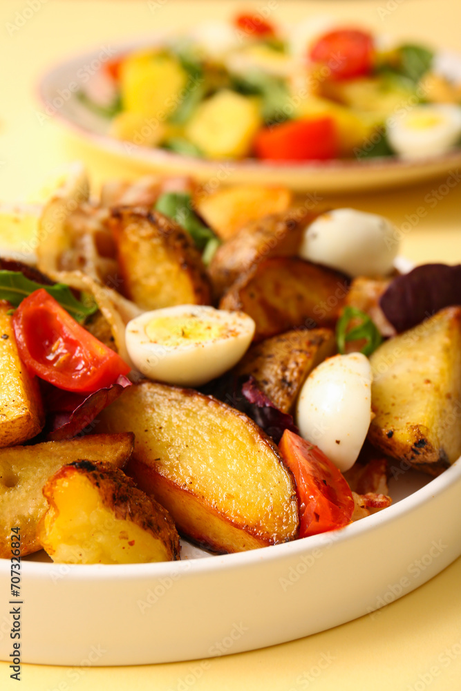 Plate of tasty potato salad with eggs, tomatoes and bacon on beige background, closeup Plate of tasty potato salad with eggs, tomatoes and bacon on beige background, closeup