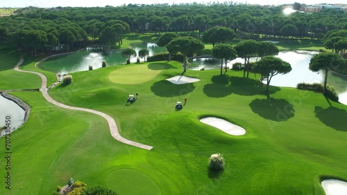 Players on the golf course aerial view. Golf car. Active pastime. Type of sport