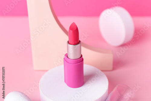 Decorative plaster podiums and lipstick on pink background © Pixel-Shot