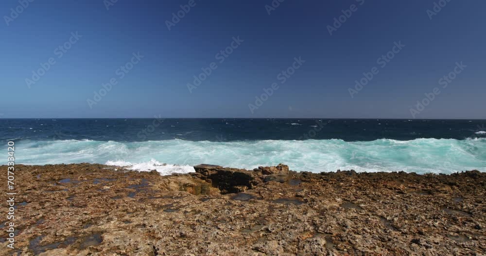 Waves crashing on rock shore in Aruba - Wide Shot Waves crashing on rock shore in Aruba - Wide Shot