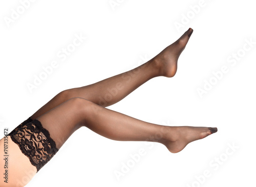 Women's legs in black stockings on a white background. photo
