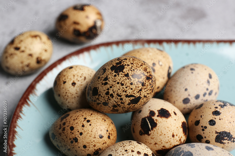 Plate with fresh quail eggs on table, closeup Plate with fresh quail eggs on table, closeup