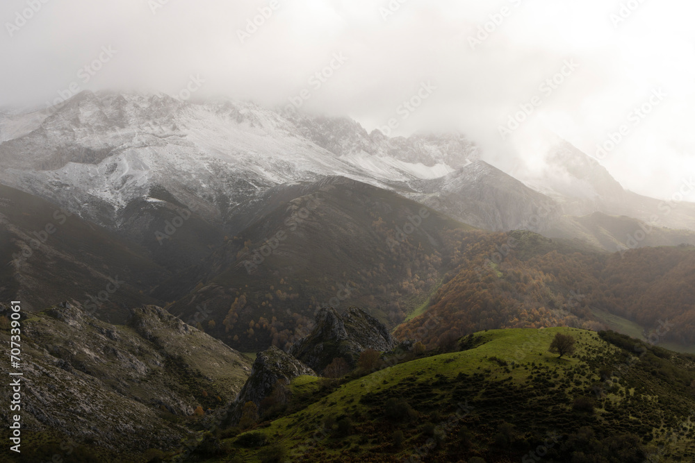 Panoramic landscape of natural park in northern Spain Cantabrian mountain range with peaks and autumn forest on a cloudy overcast day