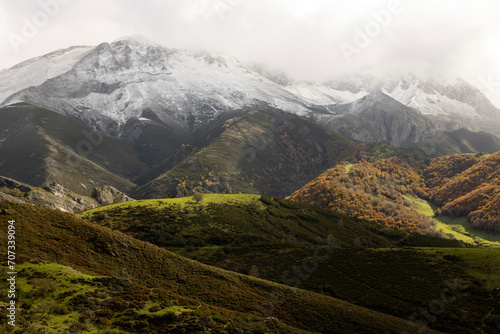 Panoramic landscape of natural park in northern Spain Cantabrian mountain range with peaks and autumn forest on a cloudy overcast day photo