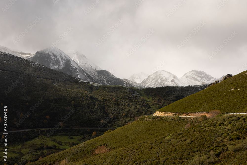 Las ubiñas mountain landscape with vehicle road and snowy peaks during autumn in northern Cantabrian mountains
