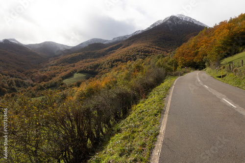 Las ubiñas mountain landscape with vehicle road and snowy peaks during autumn in northern Cantabrian mountains