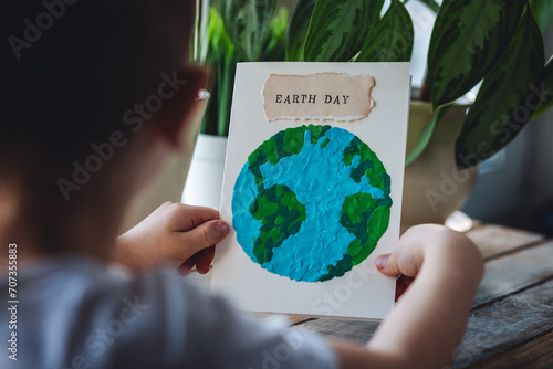 Concept of educational ecological programs for kindergarten and school. Making craft handmade postcard for the earth day. Teaching conscious sustainable lifestyle to children. Handicraft