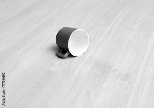 Wooden laminate floor with overturned cup of water