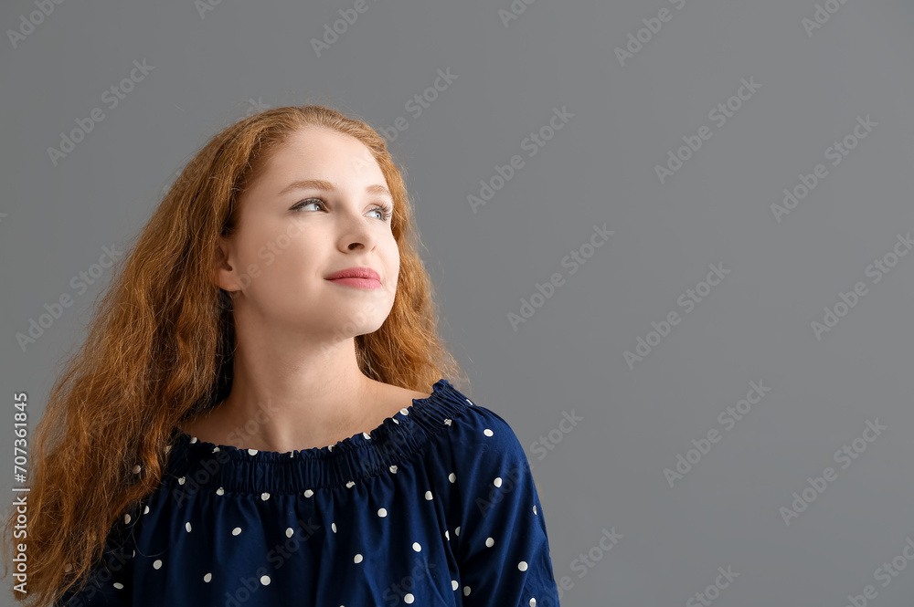 Portrait of pretty redhead woman on grey background Portrait of pretty redhead woman on grey background