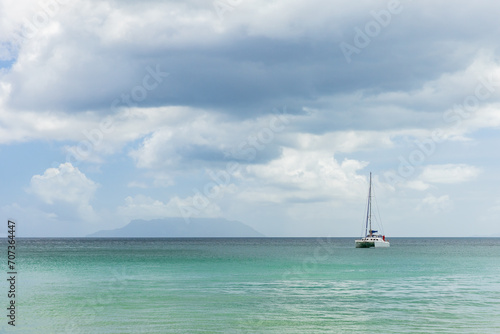 Sailing boat is near Mahe island, Seychelles. Beau Vallon beach. Landscape photo