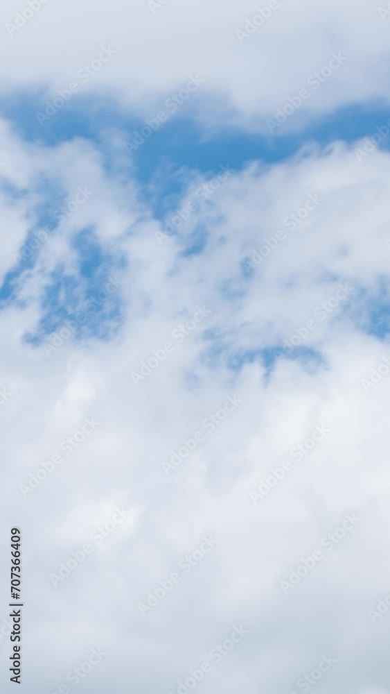 Fluffy white clouds moving fast in time-lapse. Sunny weather, cloudy heaven background. Vertical time-lapse of puffy clouds in bright blue sky, perfect background for your title text or logo
Fluffy white clouds moving fast in time-lapse. Sunny weather, cloudy heaven background. Vertical time-lapse of puffy clouds in bright blue sky, perfect background for your title text or logo