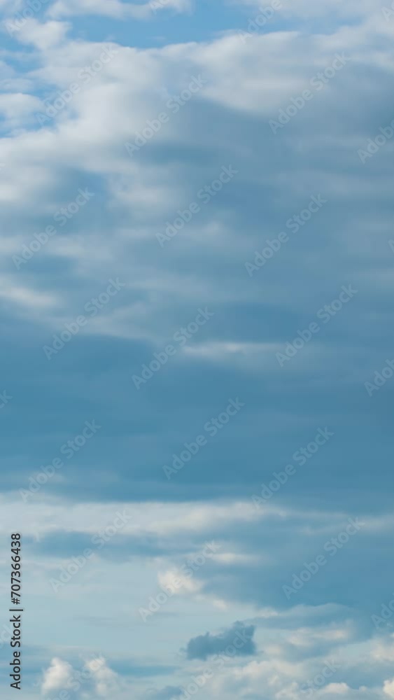 Fluffy white clouds moving fast in time-lapse. Sunny weather, cloudy heaven background. Vertical time-lapse of puffy clouds in bright blue sky, perfect background for your title text or logo
Fluffy white clouds moving fast in time-lapse. Sunny weather, cloudy heaven background. Vertical time-lapse of puffy clouds in bright blue sky, perfect background for your title text or logo