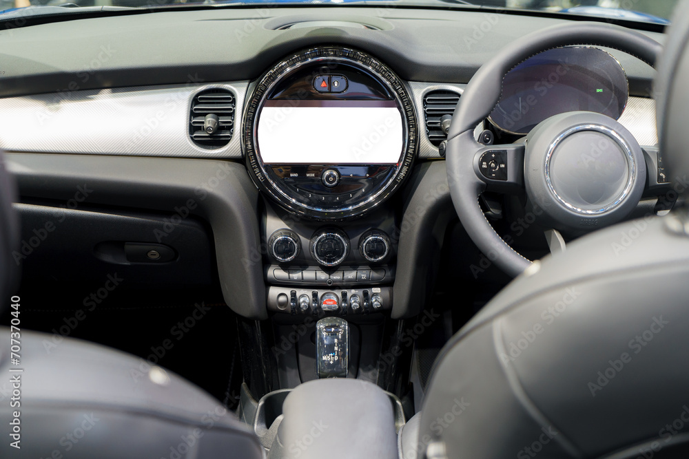 White mockup of digital display screen on the dashboard of a modern car.