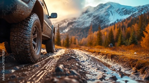 Obraz na płótnie Tire of an off-road car driving on mud in the mountains w salonie