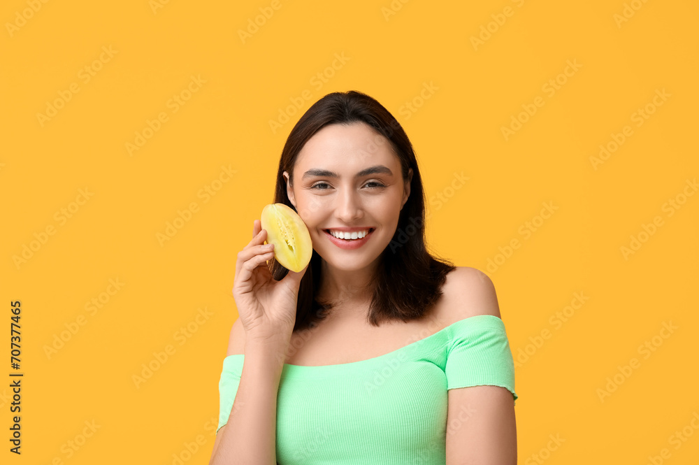 Beautiful young woman with chikoo fruit on yellow background Beautiful young woman with chikoo fruit on yellow background