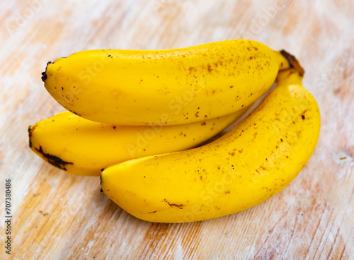 Image of bananas, ripe, tasty, lying on surface.