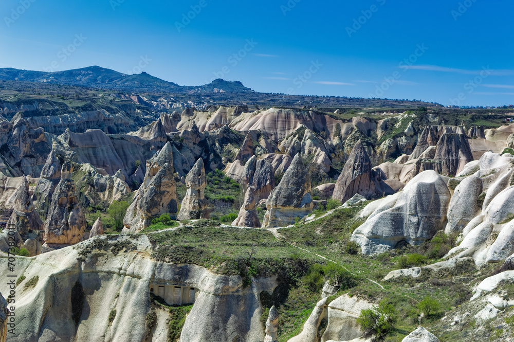 Cappadocia landscape soft volcanic rock, shaped by erosion into towers.