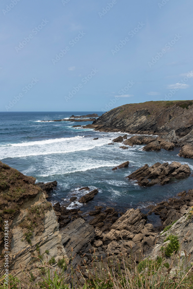 a serene yet dynamic natural beauty of a rocky coastline with waves crashing under a clear sky a serene yet dynamic natural beauty of a rocky coastline with waves crashing under a clear sky