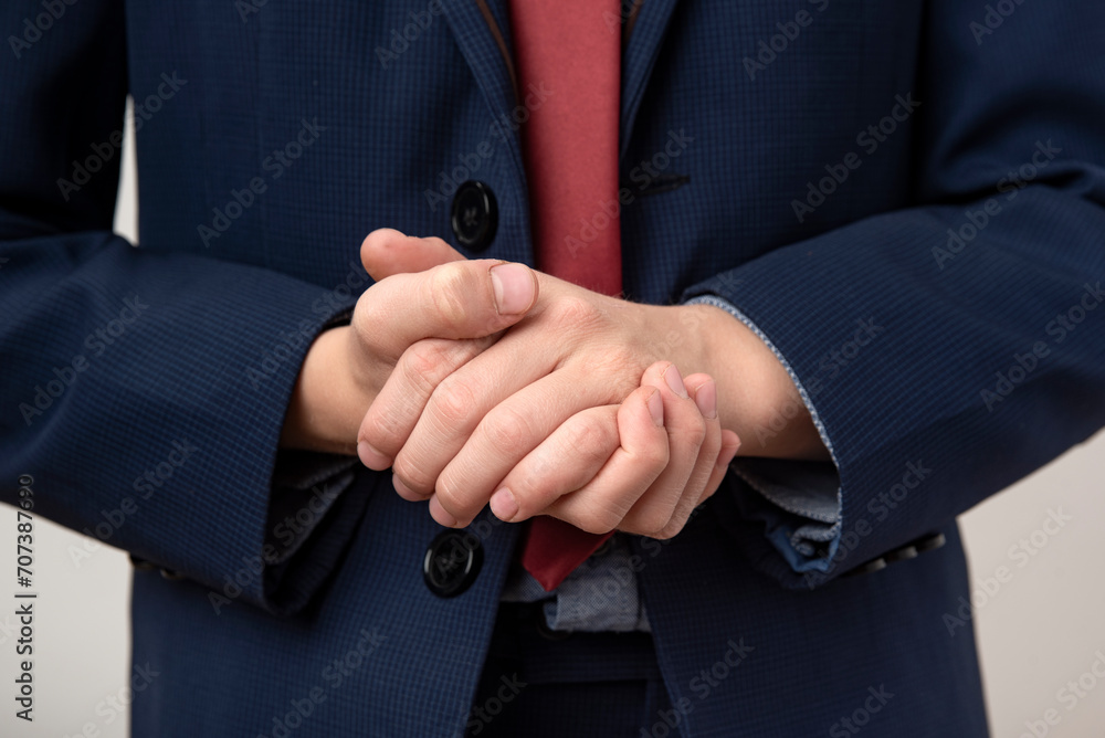 Businessman holding his hands together, close-up. Business concept
