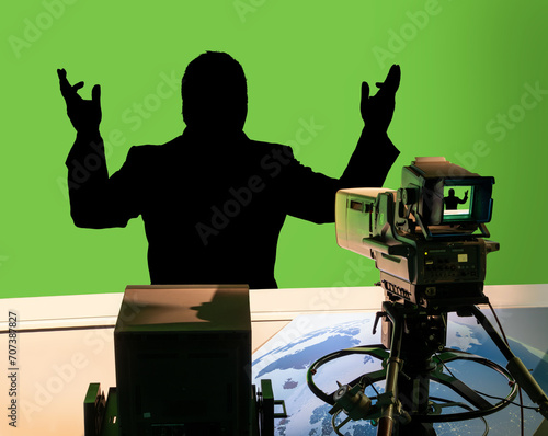 A black silhouette of man in a television studio