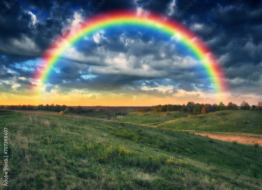 Beautiful rainbow over the field. Agricultural landscape. Nature of Ukraine Beautiful rainbow over the field. Agricultural landscape. Nature of Ukraine