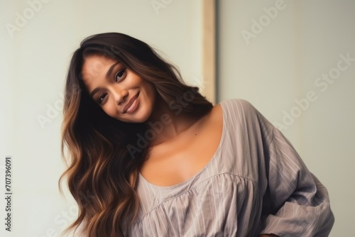 Portrait of a beautiful young woman smiling and looking at camera.