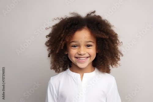 Portrait of happy african american little girl with curly hair © Inigo