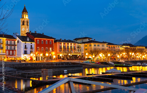 Townscape of Ascona, Switzerland. View of Lake Maggiore, embankment and Church of Saints Peter and Paul in evening.