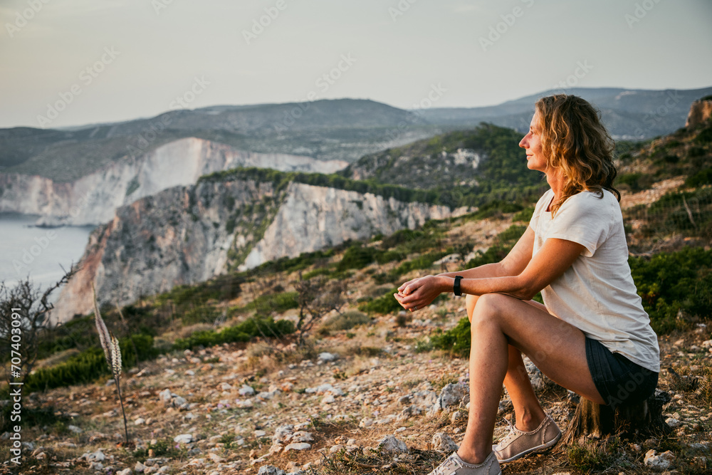 woman tourist relaxing and watching rocks in the sea