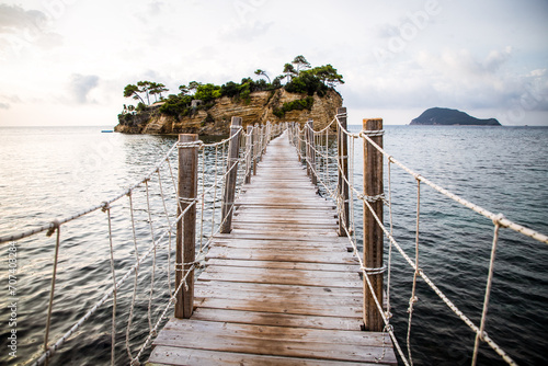 wooden footbridge leading to the small island of Agios Sostis on Zakynthos, Greece, during a sunny summer day