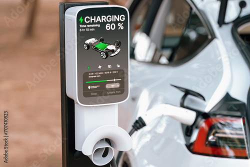 Electric car recharging battery at outdoor EV charging station for road trip or car traveling, alternative and sustainable energy technology for eco-friendly car. Perpetual