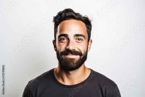 Handsome young man with beard and mustache on white background.
