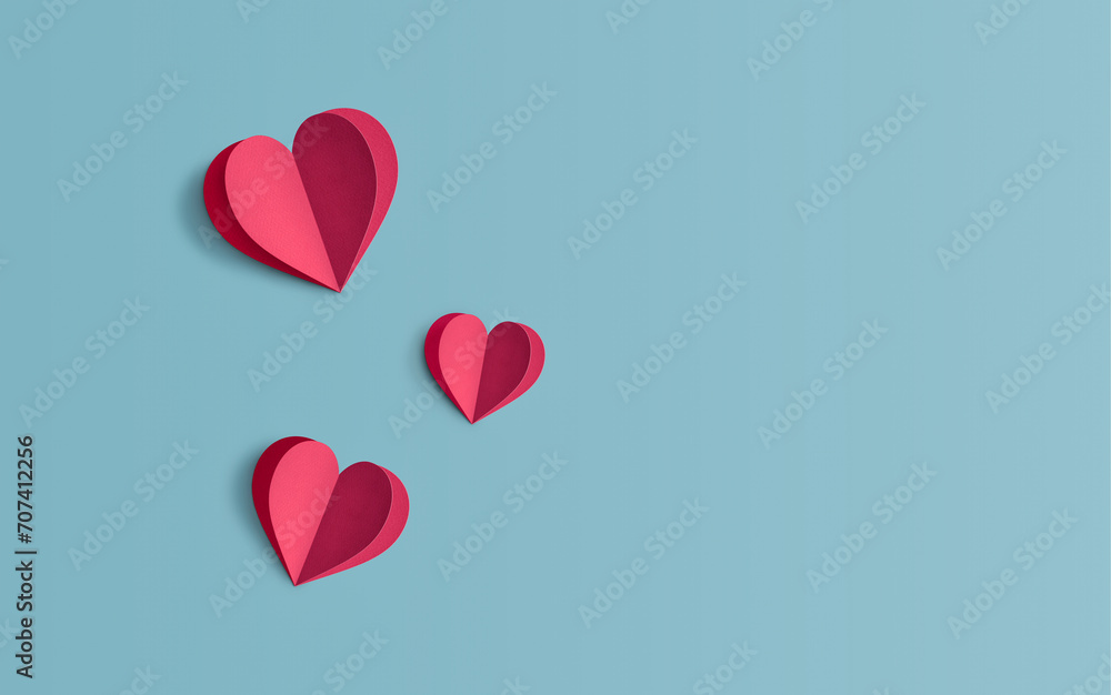 Minimal concept of Valentine's Day or love made of red paper hearts on a background of pastel blue color Creative paper art, minimal aesthetics, Love banner with space for text