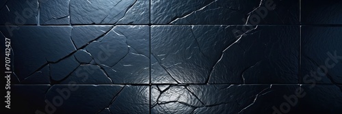 incident ray of light on a black tile wall with rocky stony texture photo