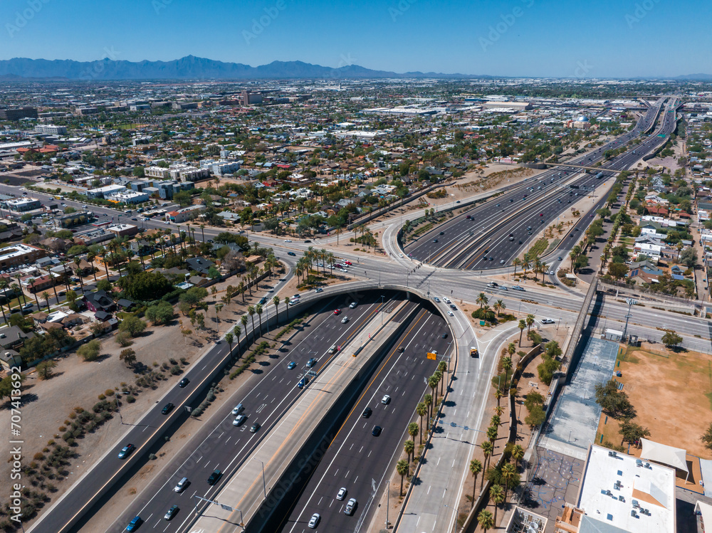 Aerial view of the highway and crossroads intersections in Phoenix, USA. Top up aerial drone view of elevated road and traffic junctions in USA metropolis during sunny day.