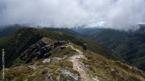 Hiking in the mountains of New Zealand featuring scenic landscape  blue sky and clouds