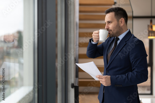Casual businessman drinking coffee at his office